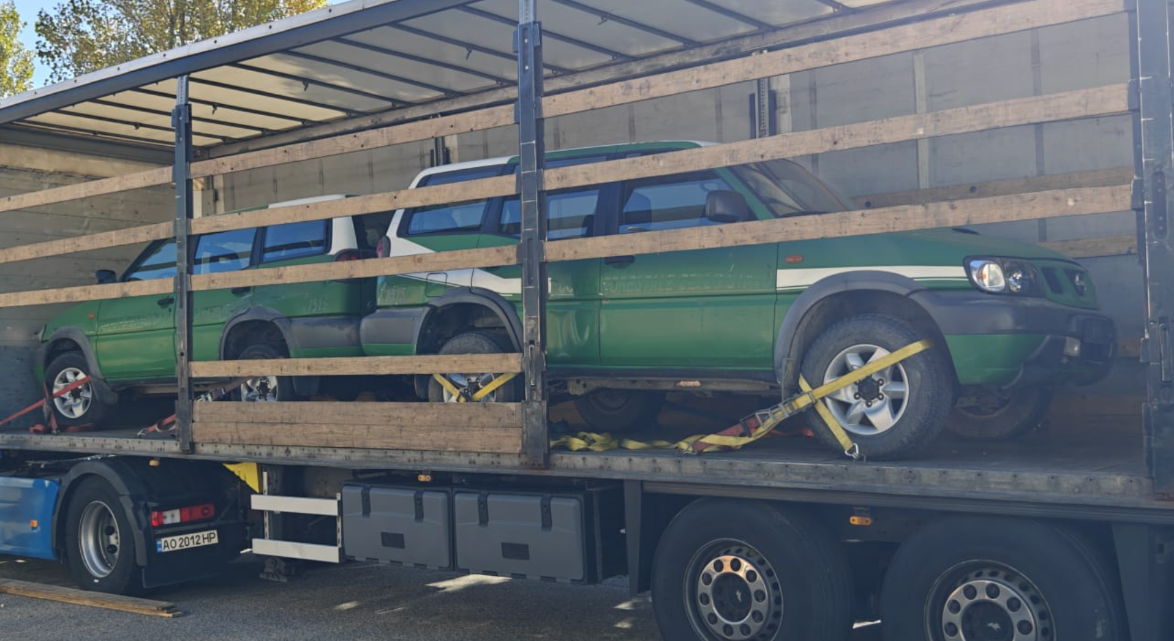 Two off-road vehicles being loaded on a truck